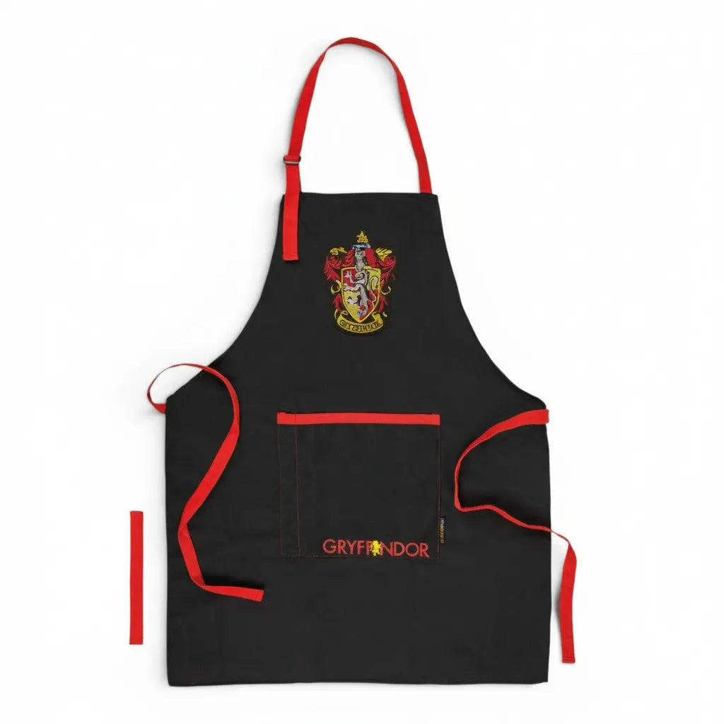 Tablier noir La boutique Aux 2 Balais Gryffondor Harry Potter avec écusson et inscription rouge, 80% polyester, 20% coton, 70x85cm.